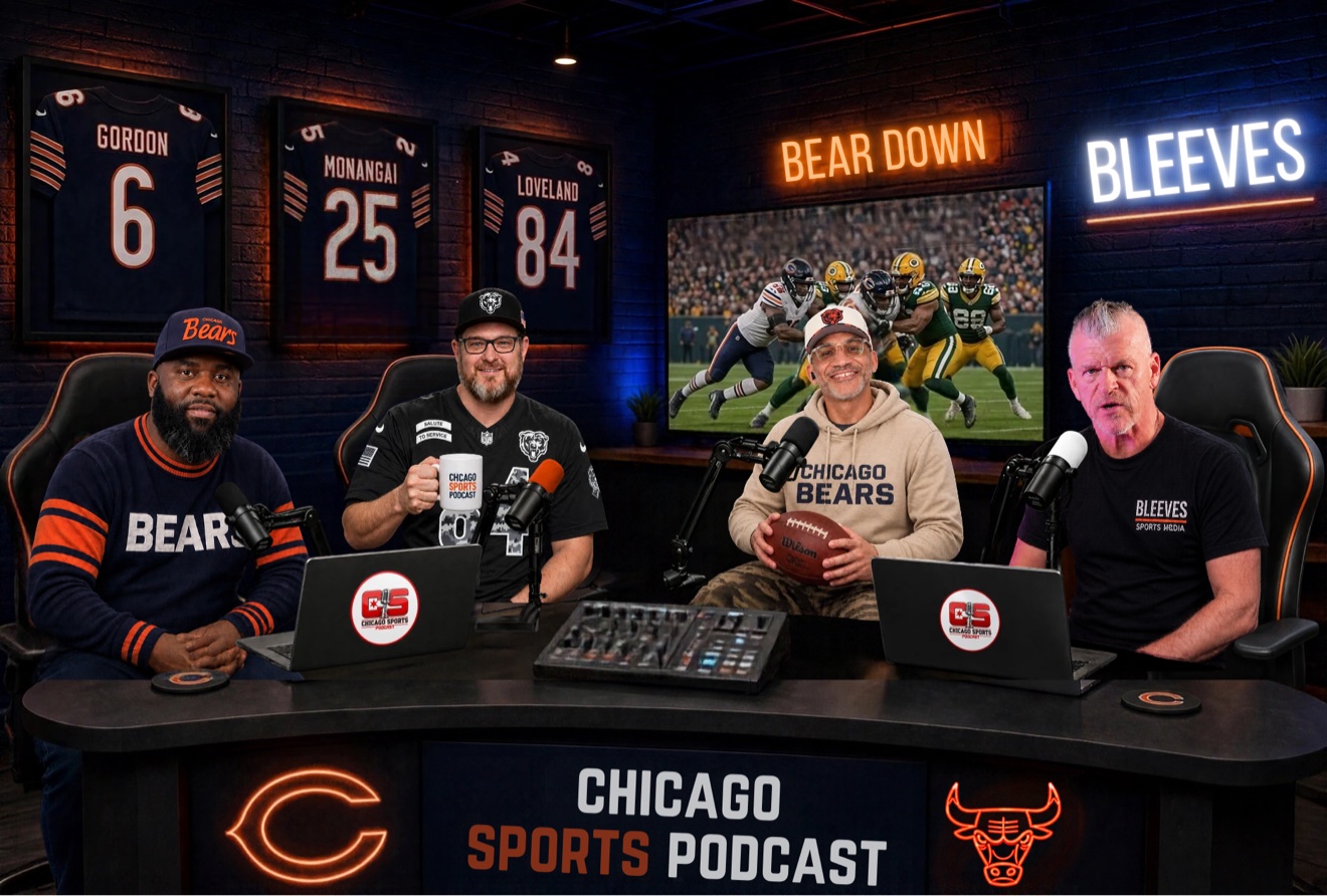 The four hosts at the curved desk in the Chicago Sports Podcast studio, left to right: D-Nice in the navy BEARS sweater and script Bears cap, Tracks in the black Salute to Service jersey holding a Chicago Sports Podcast mug, Ante-Up in the cream Chicago Bears hoodie holding a football, and Bleeves in the black BLEEVES shirt — framed Gordon 6, Monangai 25 and Loveland 84 jerseys on the brick wall behind them, orange BEAR DOWN and blue BLEEVES neon signs, and the TV showing a Bears vs Packers game